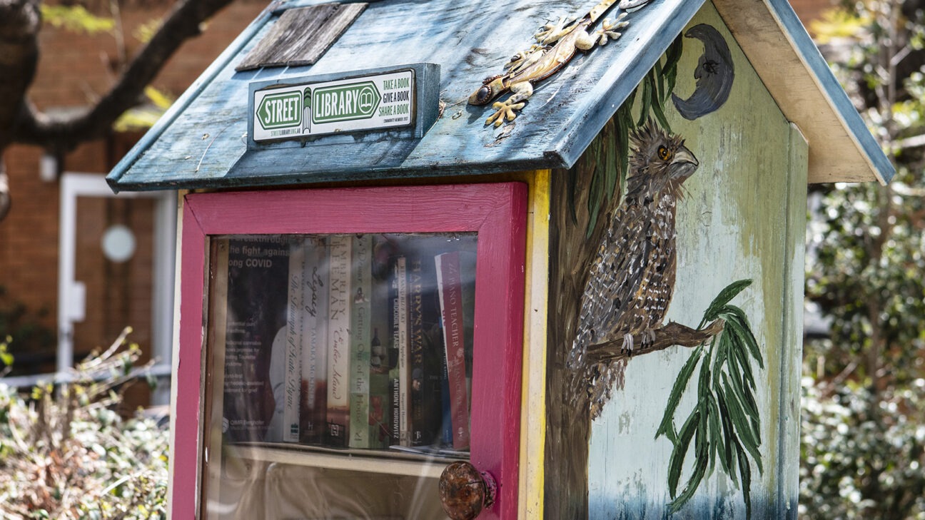 A small street library in front of the Ashgrove West Uniting Church